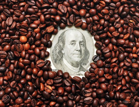 dollar on amid scattered coffee beans packing dollars. の写真素材