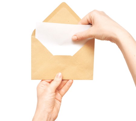 yellow envelope in the hand isolated on white background
