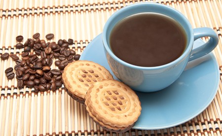 cup of coffee with biscuits and coffee beansの写真素材