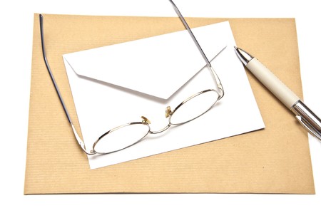 pen envelope and glasses isolated on whiteの写真素材