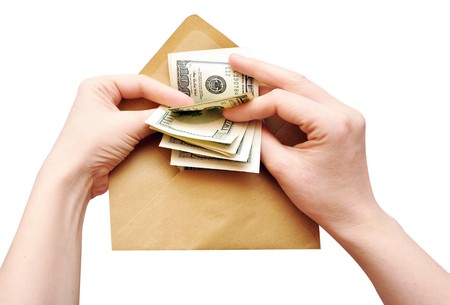 hands is counting a cash in an envelope on white