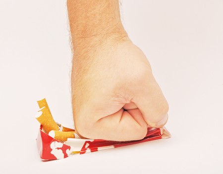 stop smoking fist with crushed pack of cigarettes の写真素材