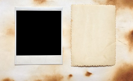 old blank photo frame over old paper backgroundの写真素材