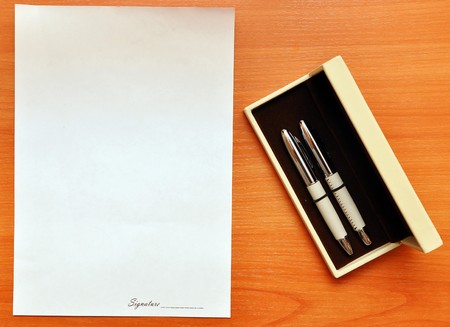 pens with a sheet of paper for signatureの写真素材