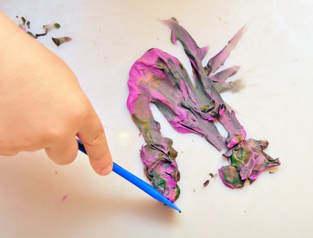 little boy sculpts figure out of plasticineの写真素材