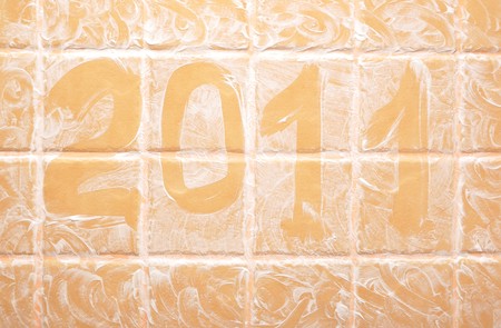 word "2011" made of foam on wall tileの写真素材