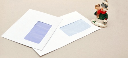 christmas toy snowman on a background of empty envelopes