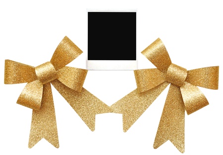  the old photo between golden bows on whiteの写真素材