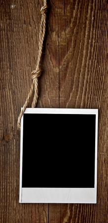 Old empty photo on wood backgroundの写真素材