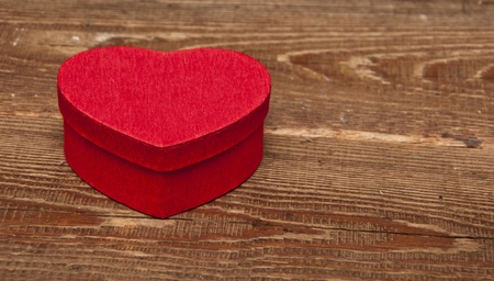 red box in heart shape on wood backgroundの写真素材