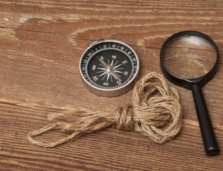 rope, compass and magnifying glass on wood backgroundの写真素材
