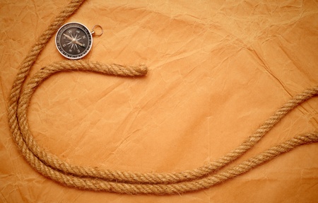 compass and rope on old yellow paper  の写真素材