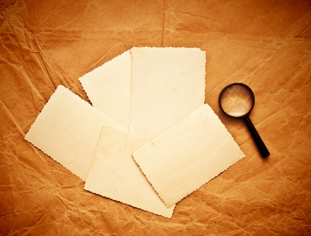 vintage photos and magnifying glass on  old paperの写真素材