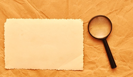 vintage photo with a decorative border and magnifying glass on old paperの写真素材