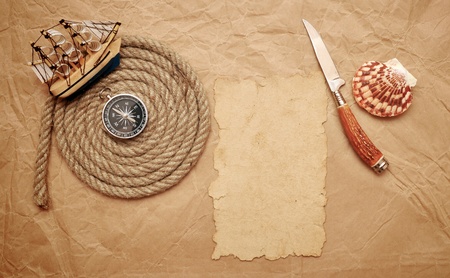  rope coil, decorative knife and model classic boat on old paperの写真素材