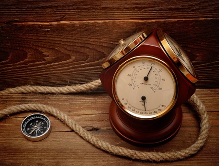 old termometer, and compass on wood backgroundの写真素材