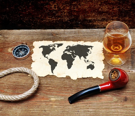 old paper, pipe and glass of cognac on wood backgroundの写真素材