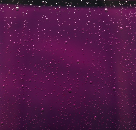 Water drops on abstract red surface