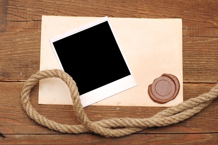 Old paper with a wax seal on a wood backgroundの写真素材