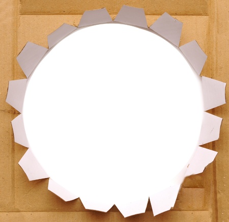 torn paper-cardboard ripped apart showing underlying layerの写真素材