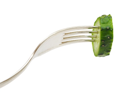 fresh cucumber on the forkの写真素材