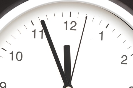 Photo of clock showing five minutes to noon 