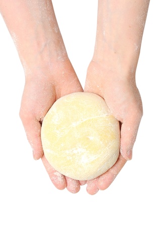 Beautiful women's hands knead the dough for baking  on whiteの写真素材