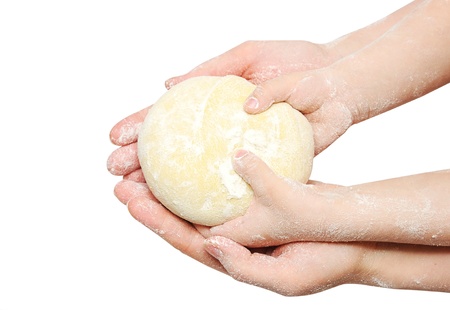 A child is helping mom to knead the dough for bakingの写真素材