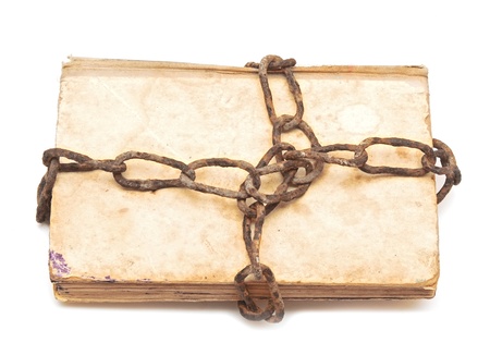 old book with chain on white background の写真素材