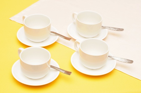 empty coffee cups with saucers