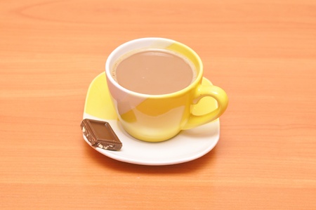yellow hot coffee cup with chocolateの写真素材