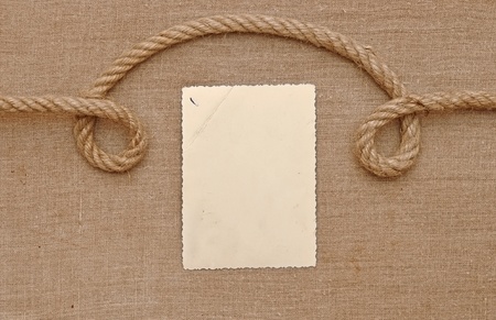 Old vintage photo with a rope on brown canvas background