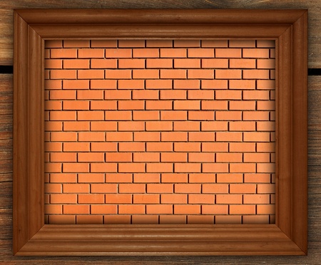 blank photo frame on old brick wall for backgroundの写真素材