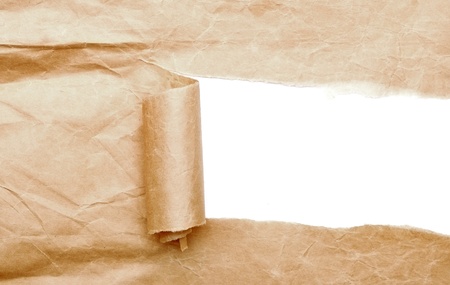 Brown package paper torn to reveal white panel ideal for copy spaceの写真素材