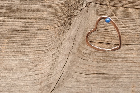 pendant shape of heart on the old wooden backgroundの写真素材