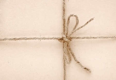 String tied in a bow on a brown paper の写真素材