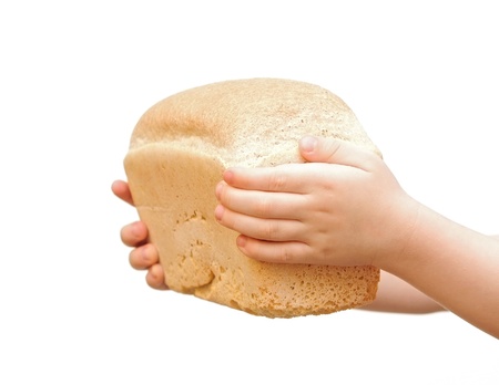 loaf of bread in children hand over white backgroundの写真素材