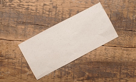 gray blank paper on old wood background 