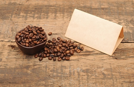 old paper for recipes and coffee beans on wooden tableの写真素材