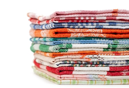 Pile of linen kitchen towels on a white background  space for your text