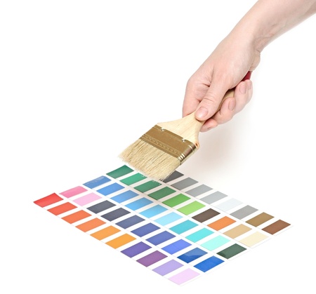 hand with brush and colorful paint samples 