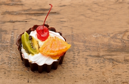 fresh baked cupcake on a dark wooden backgroundの写真素材