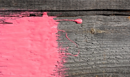 pink paint on old wooden background の写真素材
