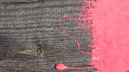 pink paint on old wooden backgroundの写真素材