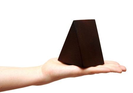 woman's hand with wooden pyramidの写真素材