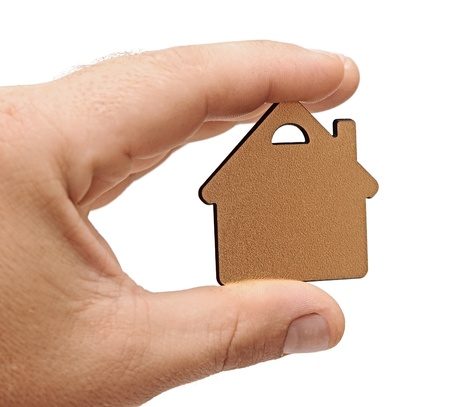 golden metallic small house in human handの写真素材