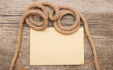 parchment paper and ship ropes on wood の写真素材