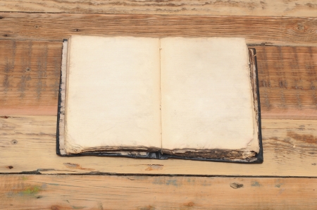 Vintage book, open, on old wooden tableの写真素材