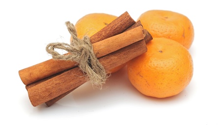 tangerines and cinnamon sticks on white backgroundの写真素材