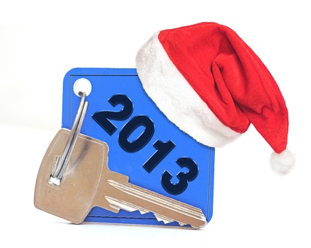 New Year 2013 date, red Santa cap on blue label with metal keyの写真素材